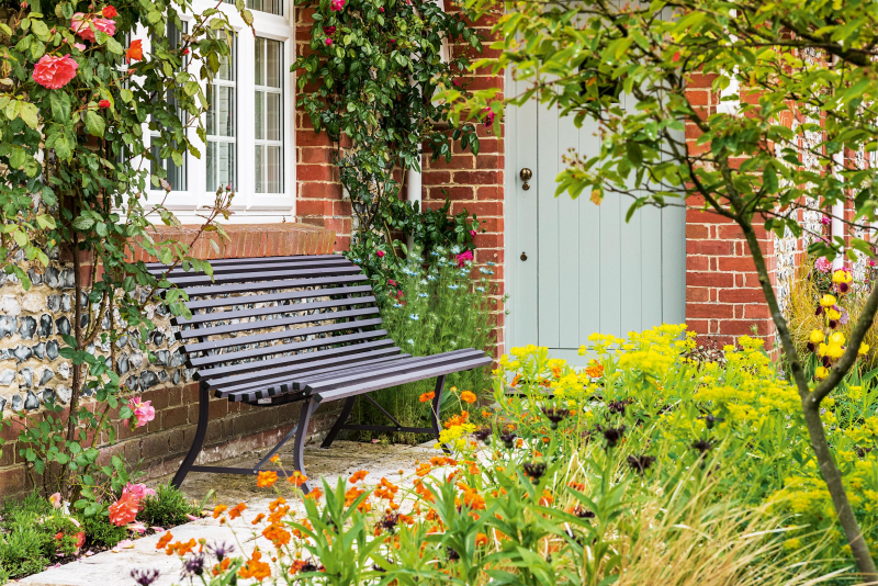 Purple Bench surrounded by yellow and orange blooms