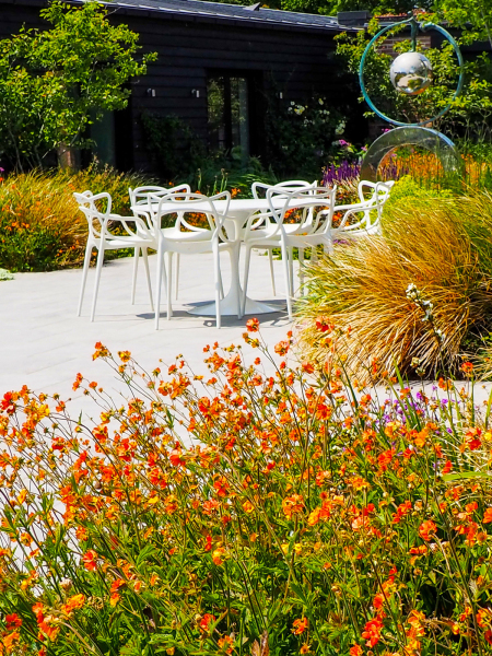 Outdoor dining table with flower beds