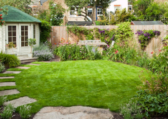 Small city garden with bright, colourful flower borders and natural stone pathway in Barnes, designed by Ann- Marie Powell, July ,UK 2009